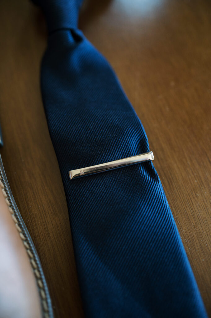 Detail shot of grooms tie clip