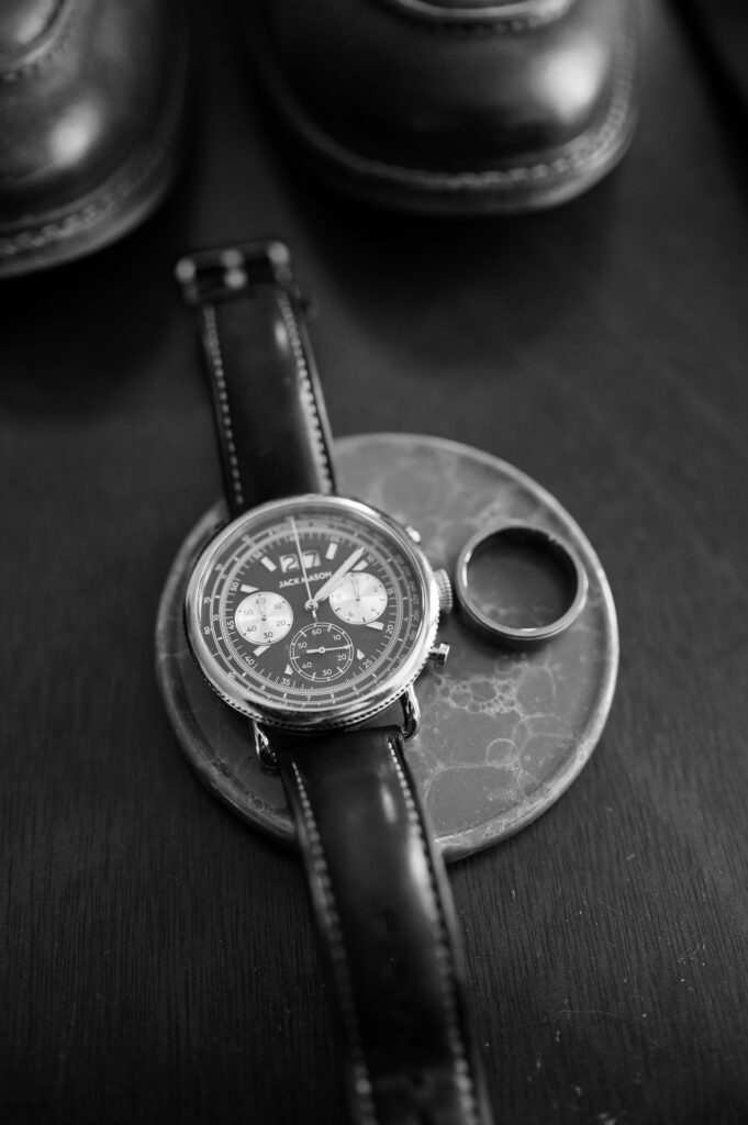 black and white detail shot of grooms watch and ring 