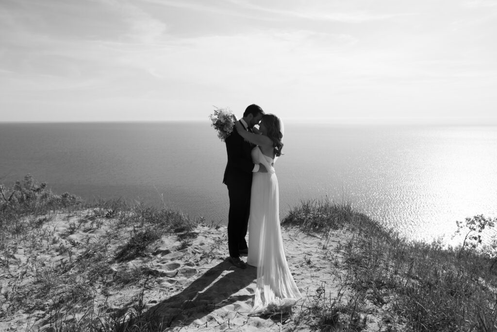 Black and white wedding portrait of bride and groom on the coast of Lake Michigan