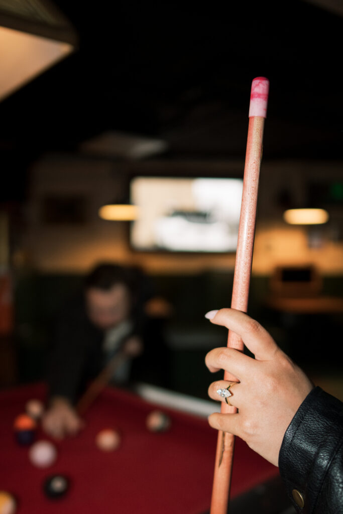 Engagement session at a bar with a pool table