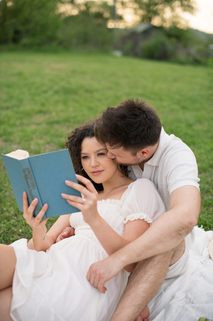 Couple reading book at engagement session in Bells Bend 
