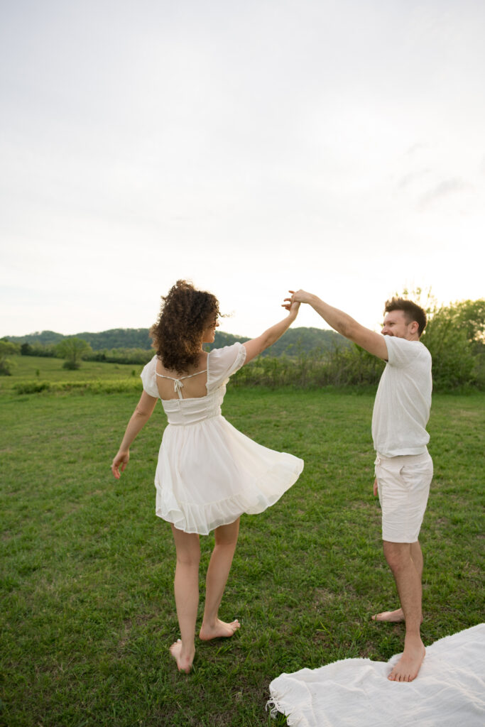 Couple dancing at their picnic for their engagement session in Nashville, Tennessee 