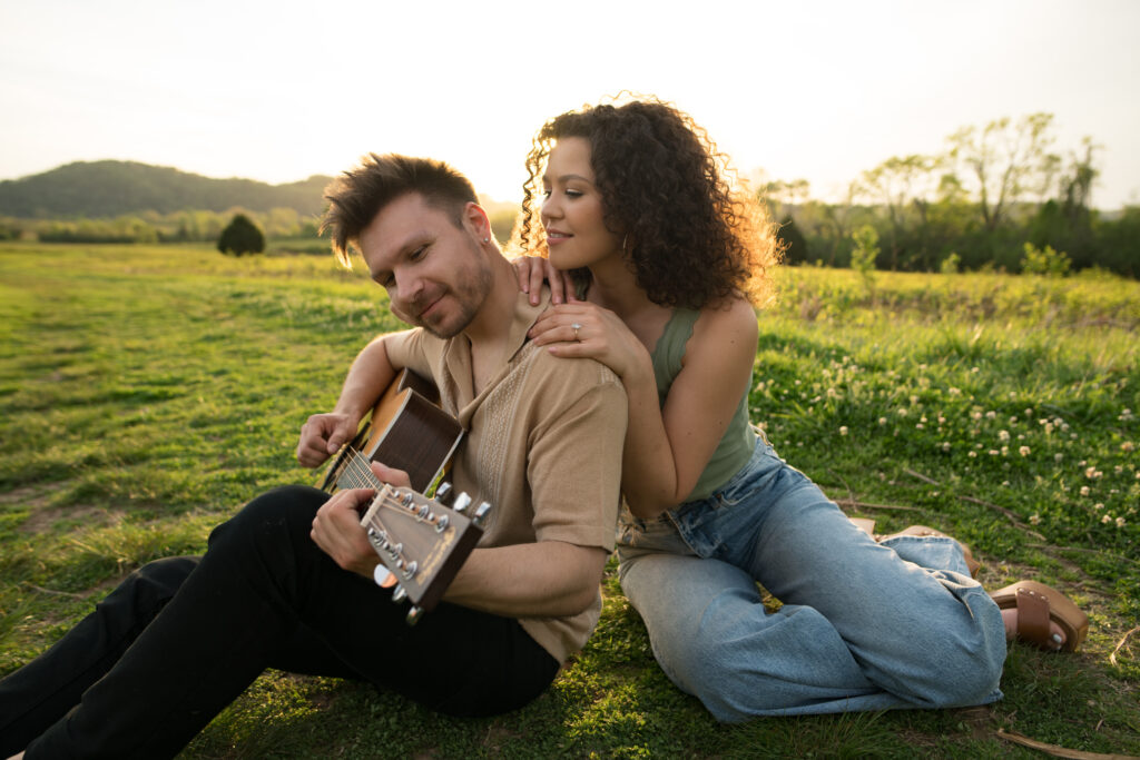 Couple playing guitar during engagement session at Bells Bend 
