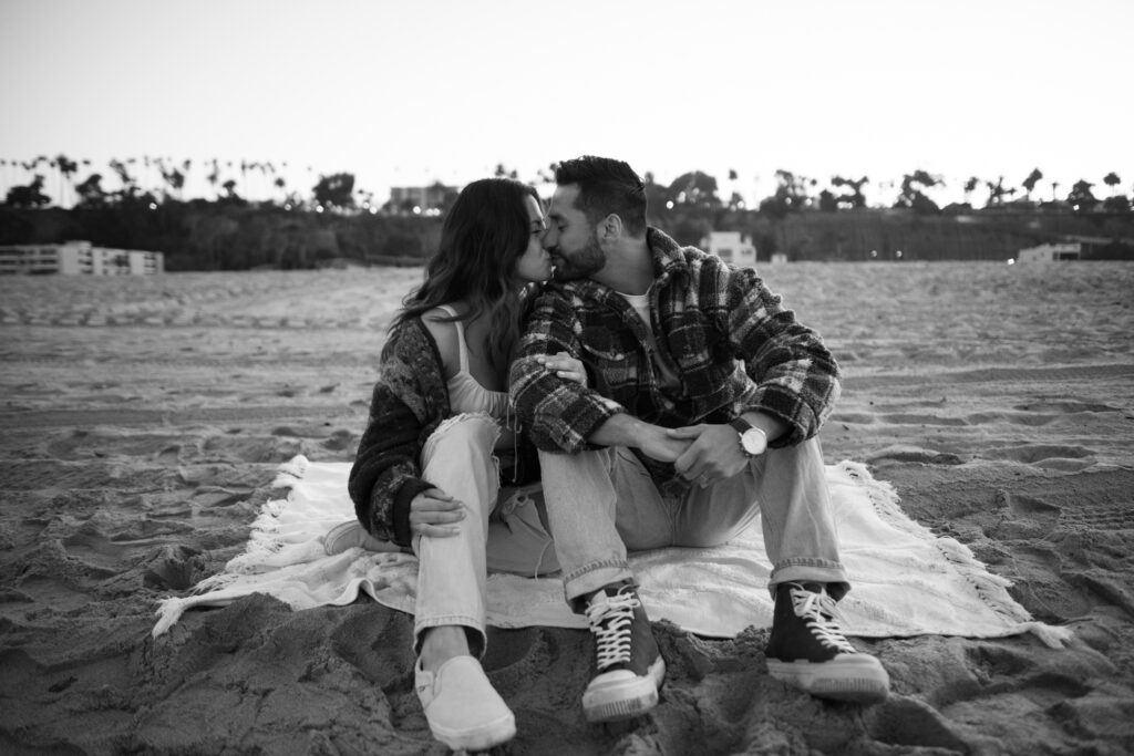 Photo of couple kissing on the beach in Santa Monica 