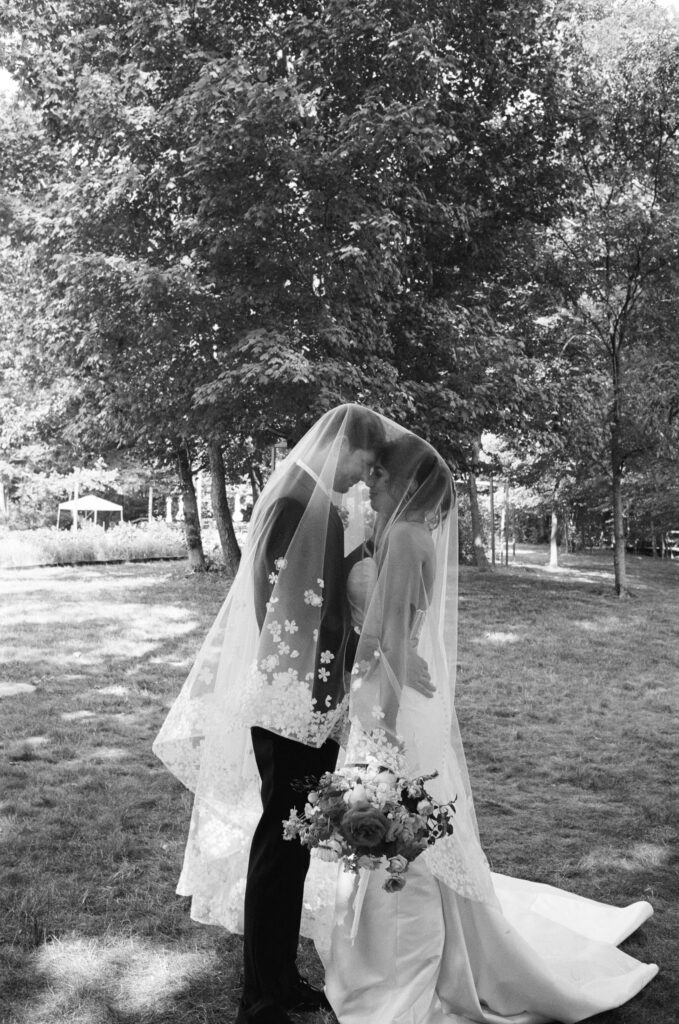 Bride and groom posing on a flower farm in Cincinnati, Ohio at their summertime wedding