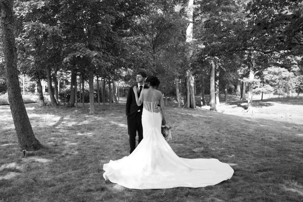 Bride and groom posing on a flower farm in Cincinnati, Ohio at their summertime wedding