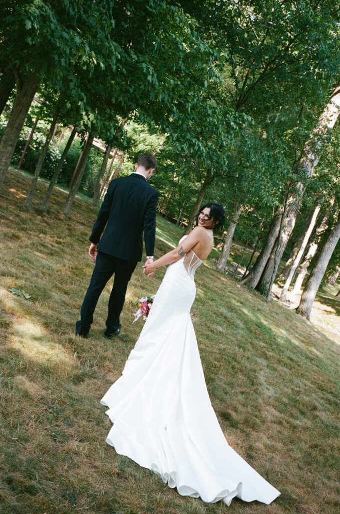 Bride and groom posing on a flower farm in Cincinnati, Ohio at their summertime wedding