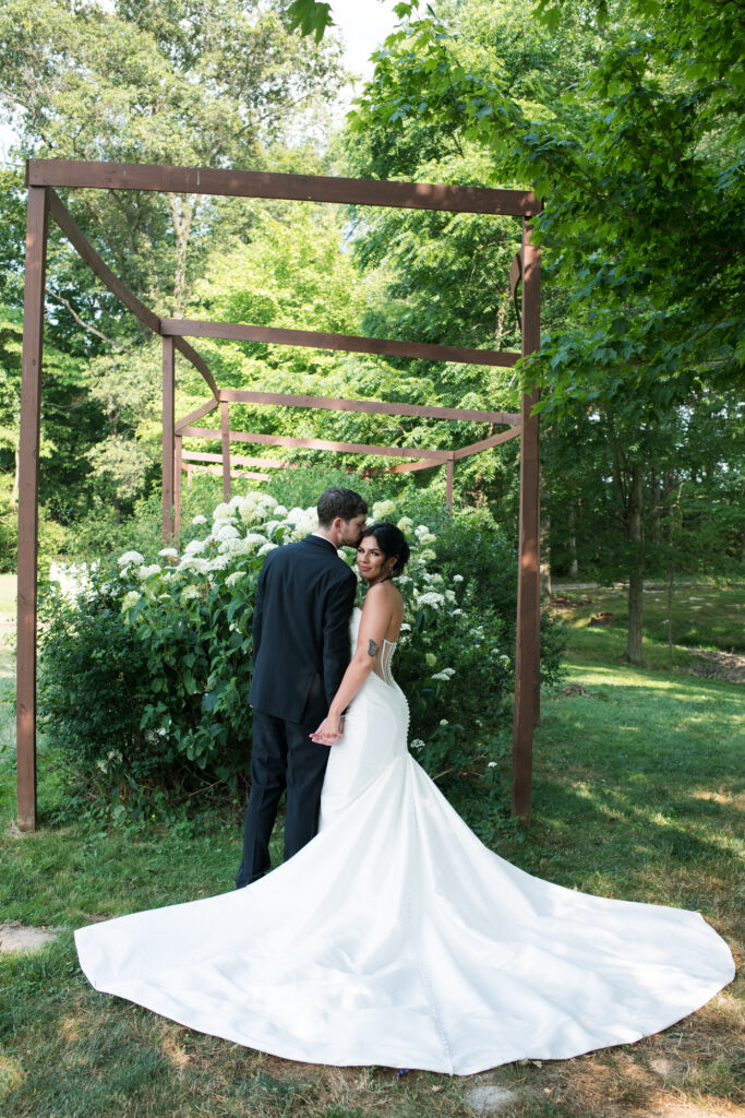 Bride and groom posing on a flower farm in Cincinnati, Ohio at their summertime wedding