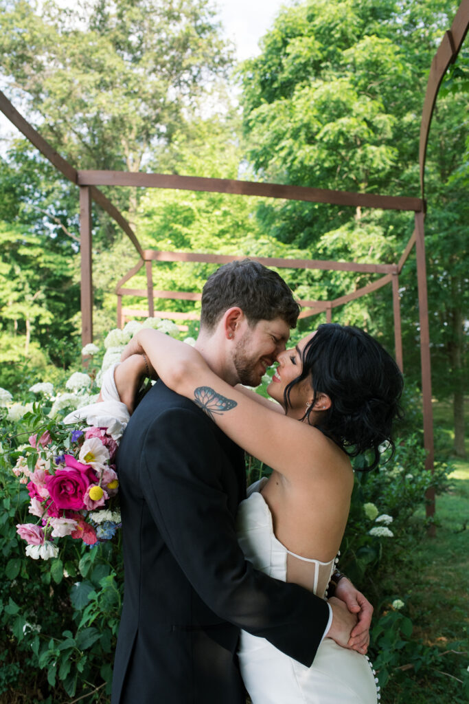 Bride and groom posing on a flower farm in Cincinnati, Ohio at their summertime wedding