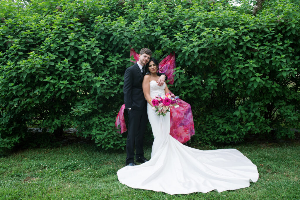 Bride and groom posing on a flower farm in Cincinnati, Ohio at their summertime wedding