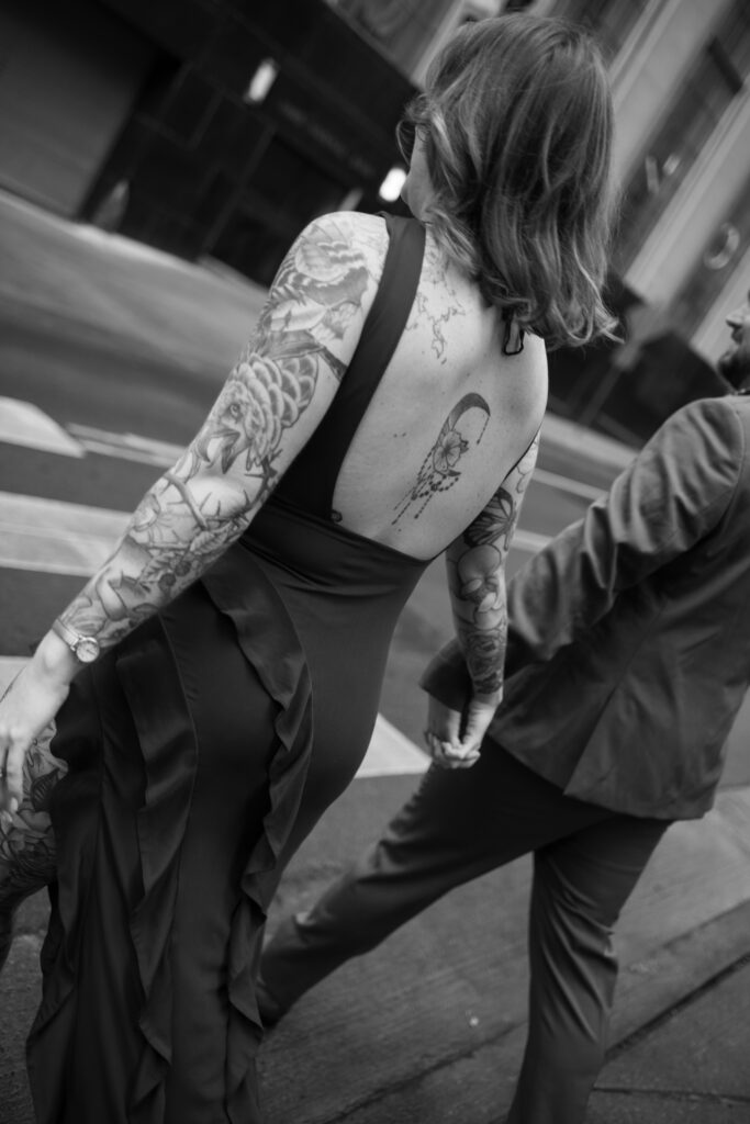 A black and white image of a couple walking across the street in Nashville, Tennessee 