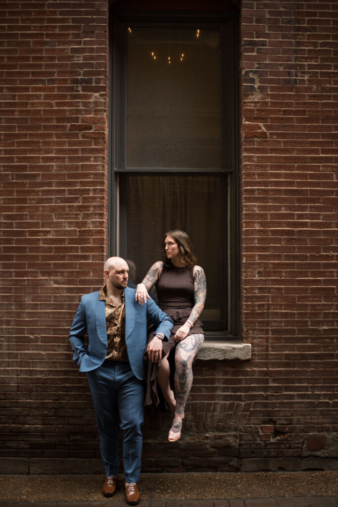 A couple, sitting in a window sill in Printer's Alley