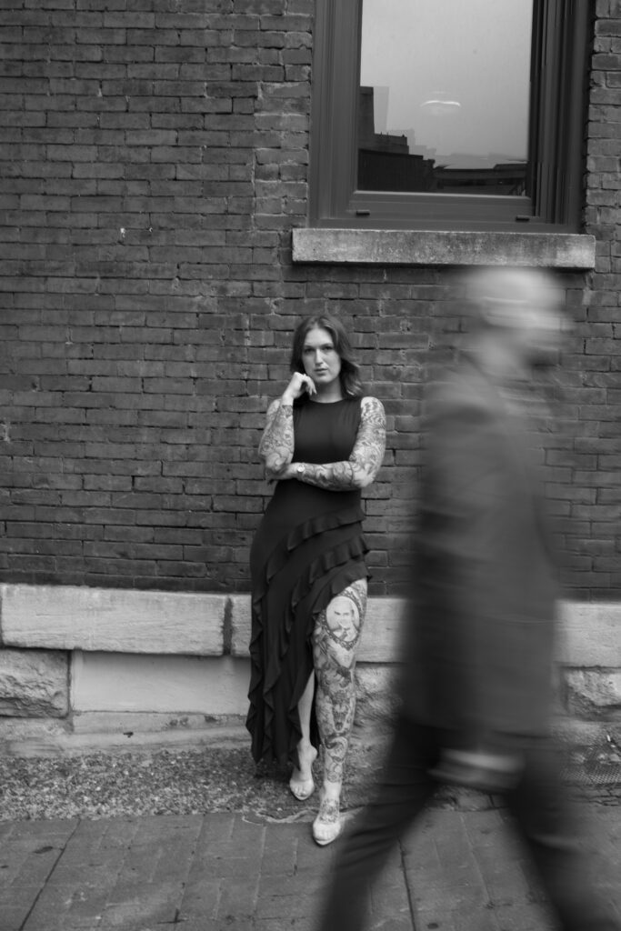 A black and white image of a couple where the guy is walking in front of the girl in Nashville, Tennessee 