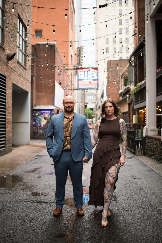 A couple posing in the middle of Printer's Alley in Nashville, Tennessee 