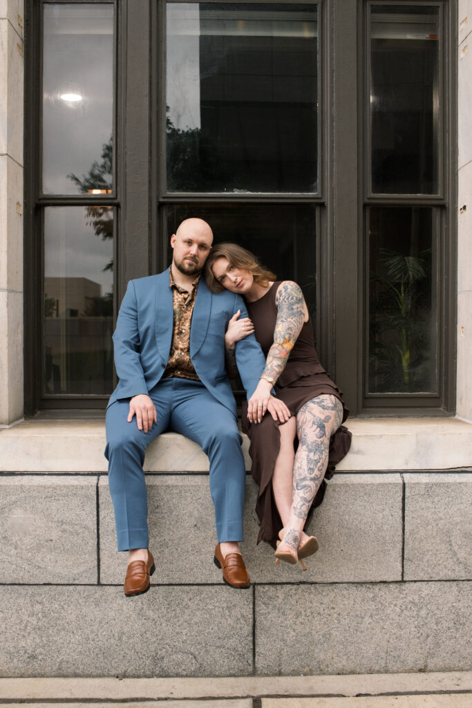 An image of a couple sitting in a window sill in Printer's Alley