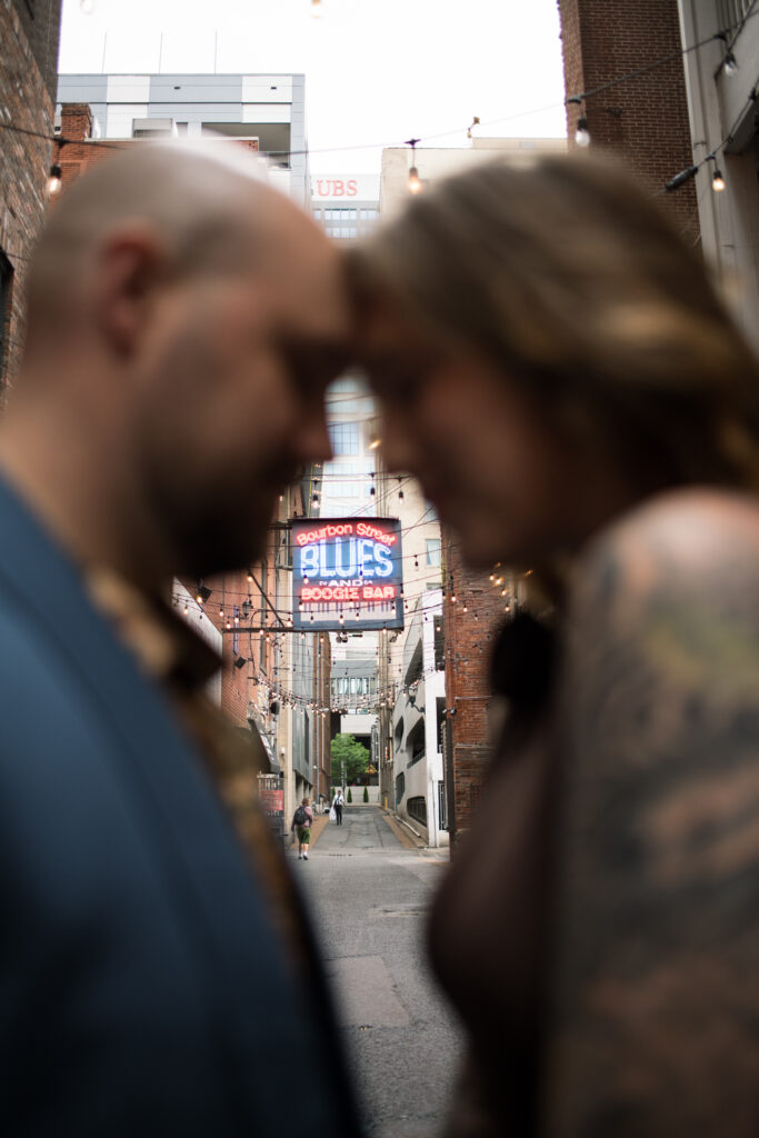 A couple posing in the middle of Printer's Alley in Nashville, Tennessee 