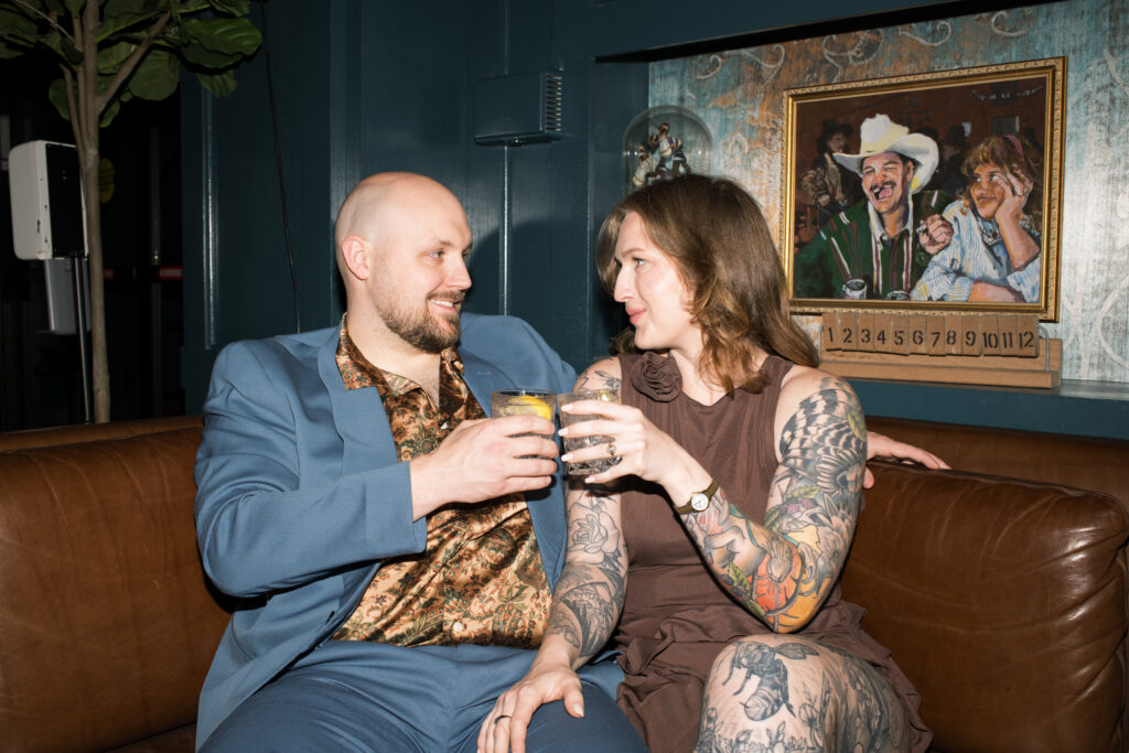 A couple doing "cheers" with their drinks at the Countrypolitan Hotel in Printer's Alley in Nashville, Tennessee