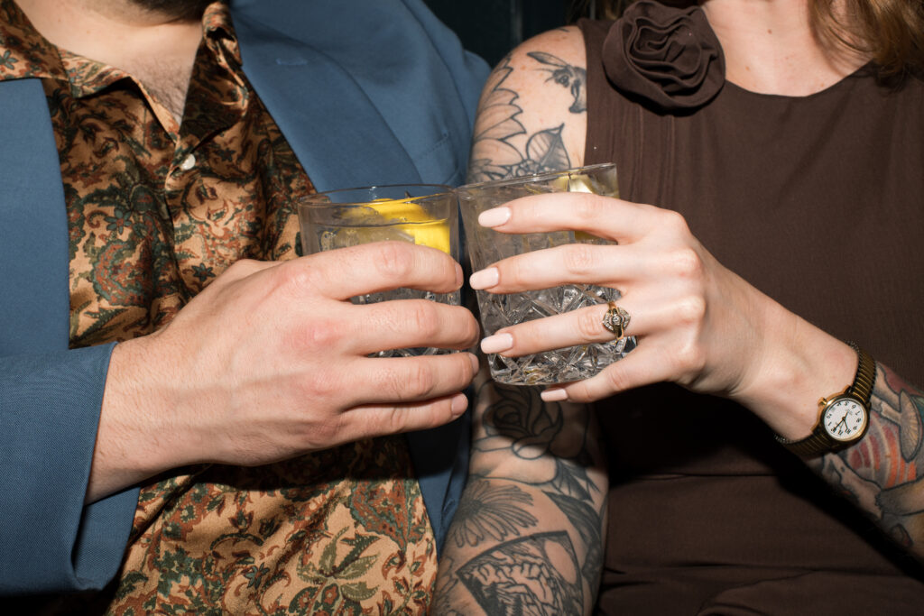 A couple doing "cheers" with their drinks at the Countrypolitan Hotel in Printer's Alley in Nashville, Tennessee