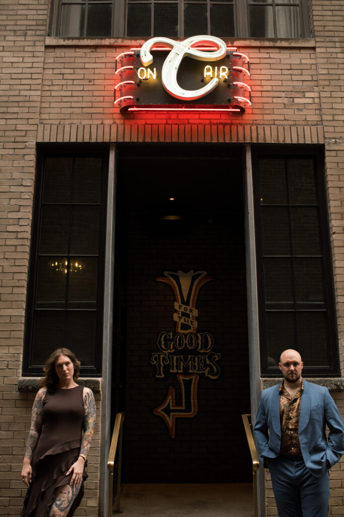 A couple posing outside of  the Countrypolitan Hotel in Printer's Alley in Nashville, Tennessee