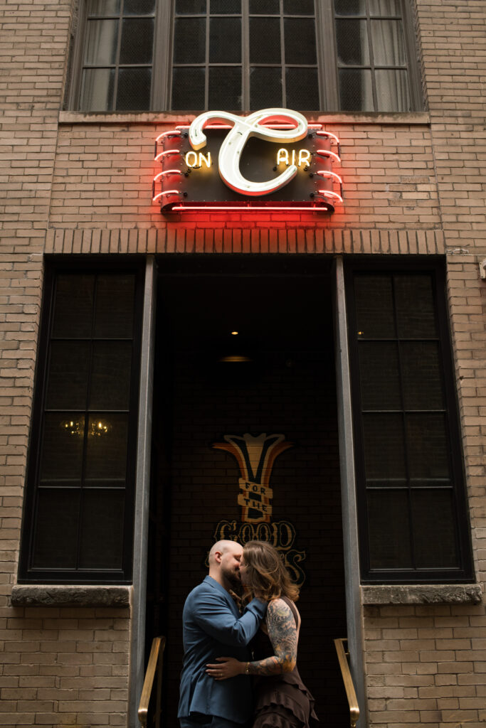 A couple kissing outside of  the Countrypolitan Hotel in Printer's Alley in Nashville, Tennessee