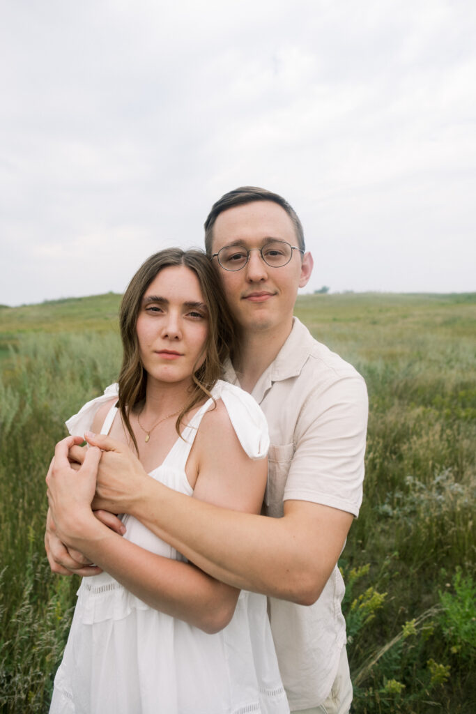 Couple looking at the camera for their summertime anniversary session in North Dakota 