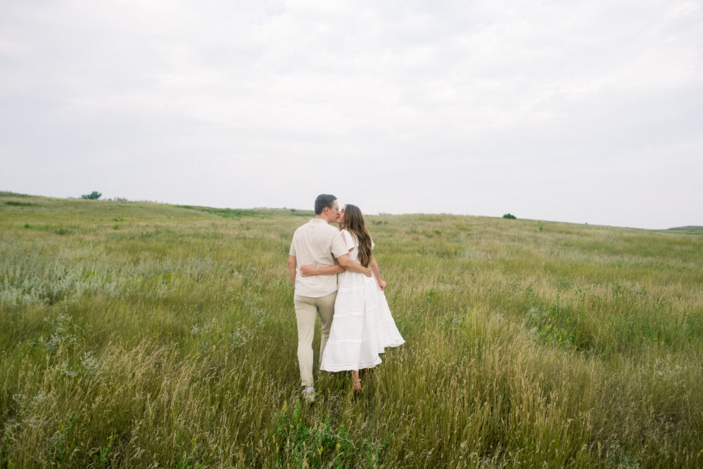 Couple kissing in the rolling hills in North Dakota