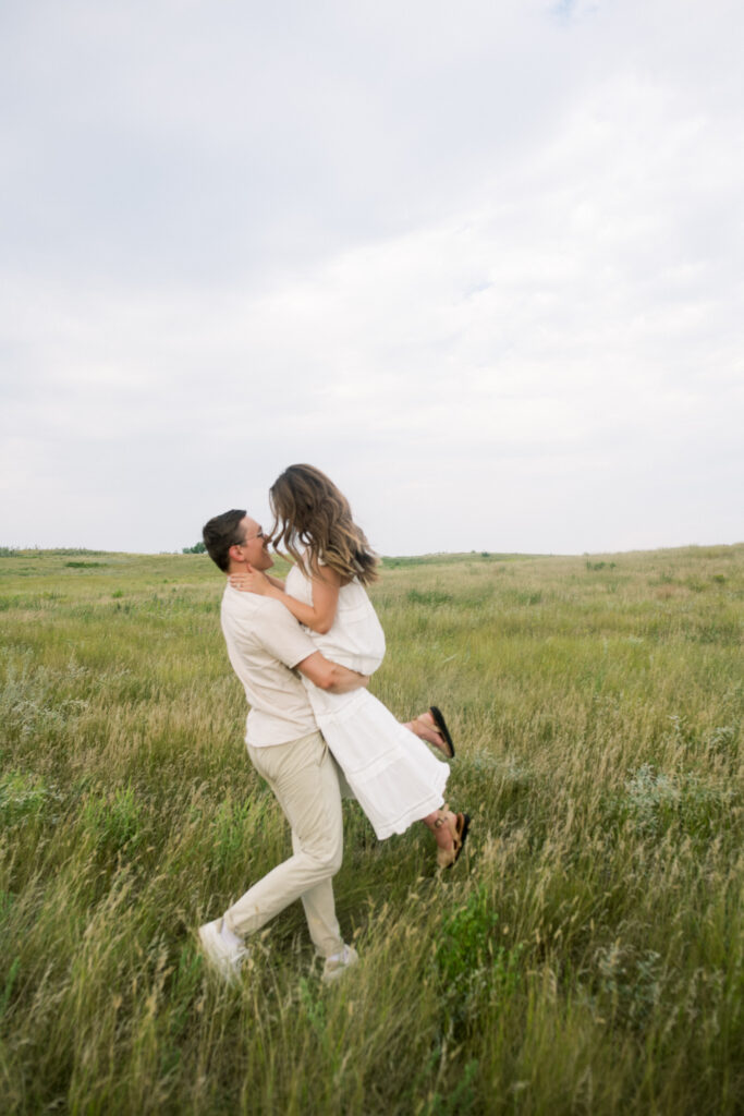 Couple kissing in the rolling hills in North Dakota