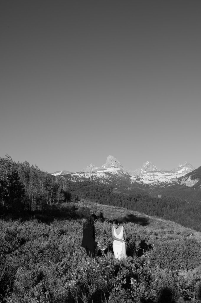 Couple posing in from of the Grand Teton mountain range in black and white 