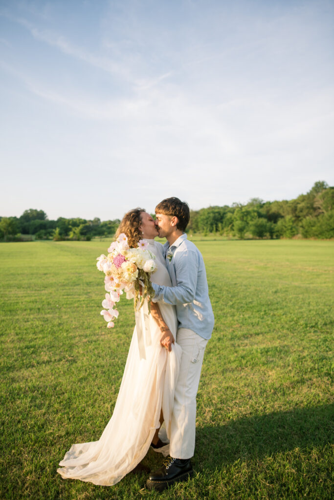 Couple running in a field on their wedding day 