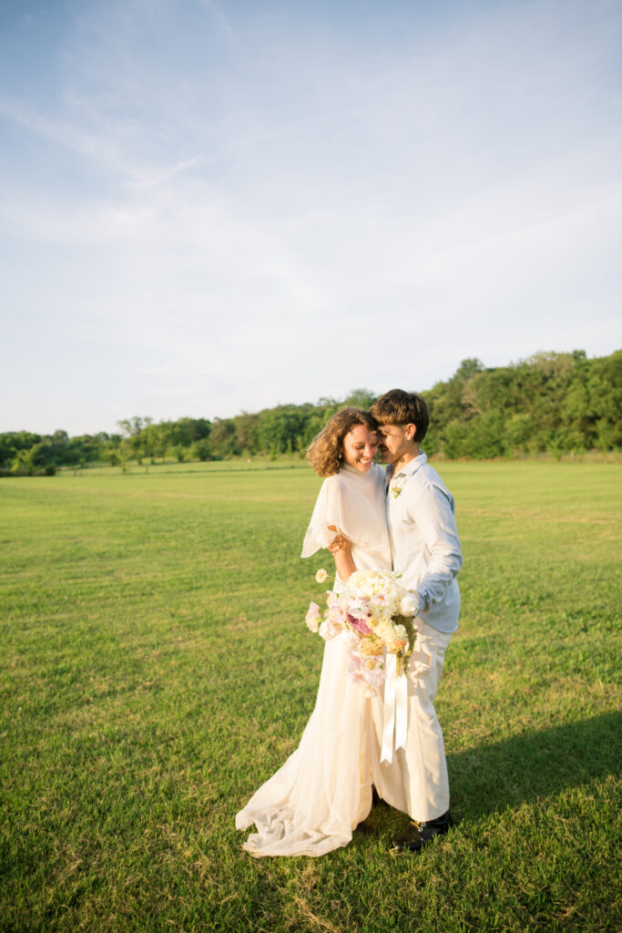 Couple running in a field on their wedding day 