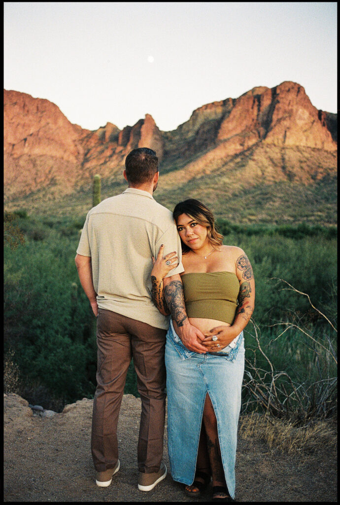 35mm film photo of a couple posing for maternity photos in the Arizona desert 