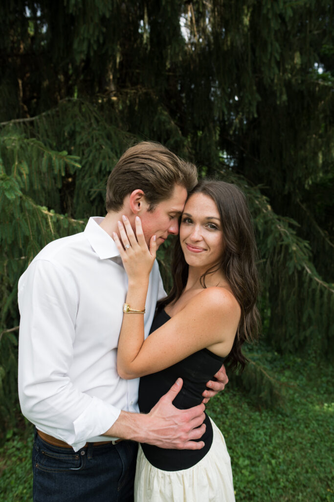 Couple posing for their engagement photos in their family backyard in Louisville, Kentucky