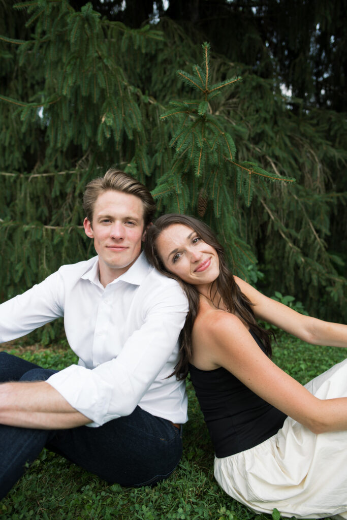 Couple posing for their engagement photos in their family backyard in Louisville, Kentucky