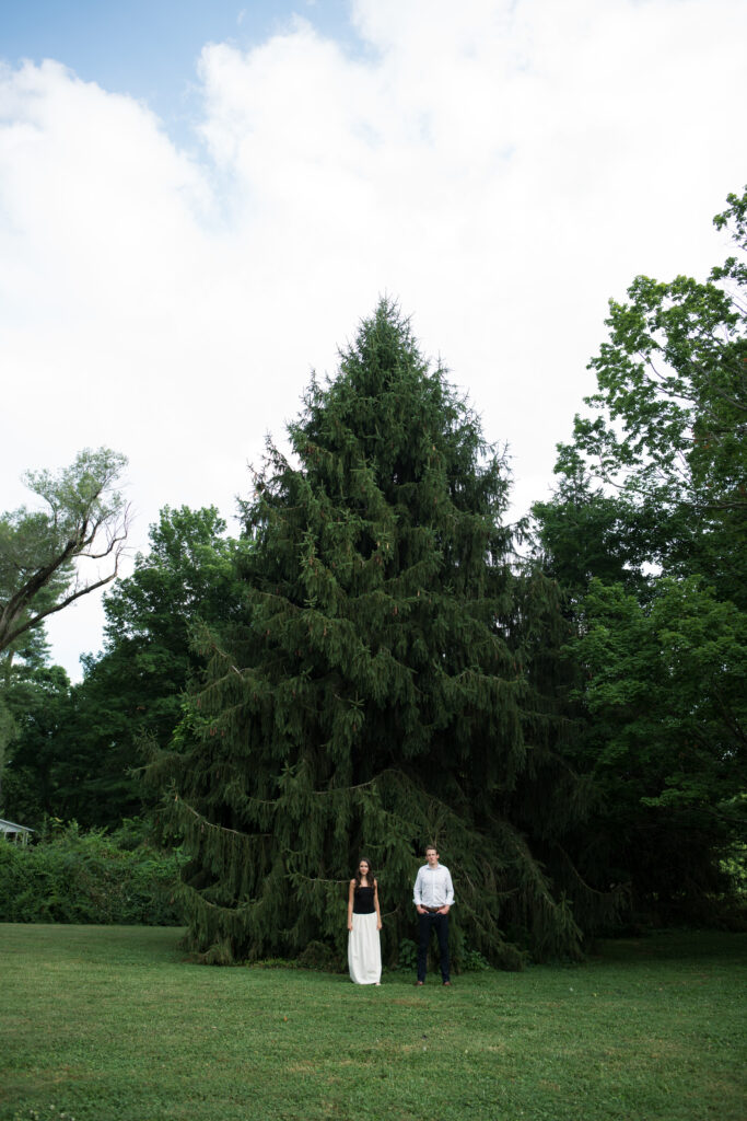 Couple posing for their engagement photos in their family backyard in Louisville, Kentucky