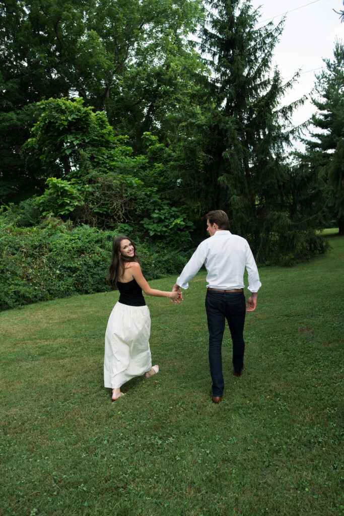 Couple posing for their engagement photos in their family backyard in Louisville, Kentucky