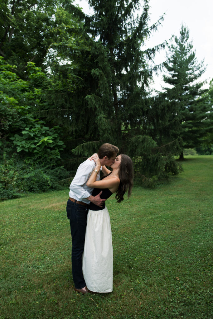 Couple posing for their engagement photos in their family backyard in Louisville, Kentucky