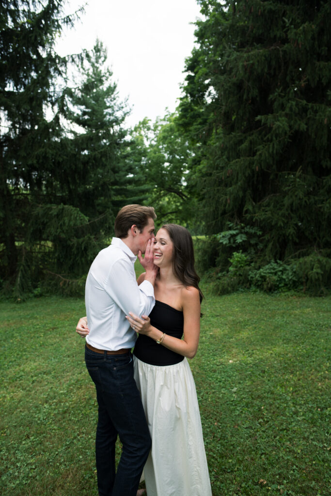 Couple posing for their engagement photos in their family backyard in Louisville, Kentucky