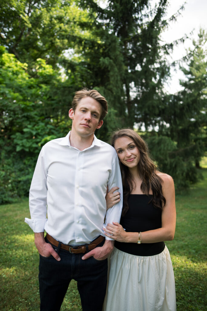 Couple posing for their engagement photos in their family backyard in Louisville, Kentucky