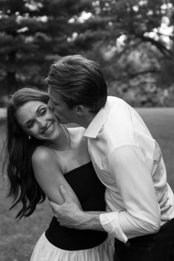 Couple posing for their engagement photos in their family backyard in Louisville, Kentucky