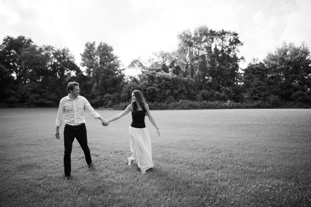 Couple posing for their engagement photos in their family backyard in Louisville, Kentucky