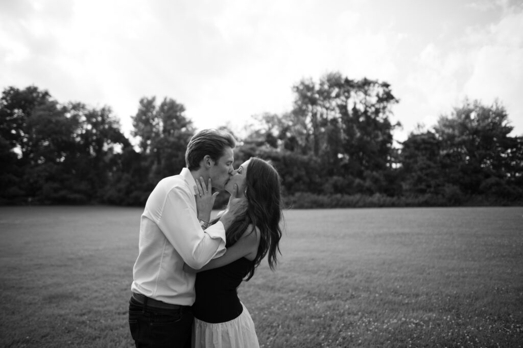 Couple posing for their engagement photos in their family backyard in Louisville, Kentucky