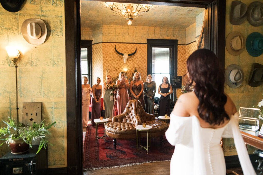 Bride's first look with her bridesmaids inside of The Urban Cowboy in Nashville, Tennessee 