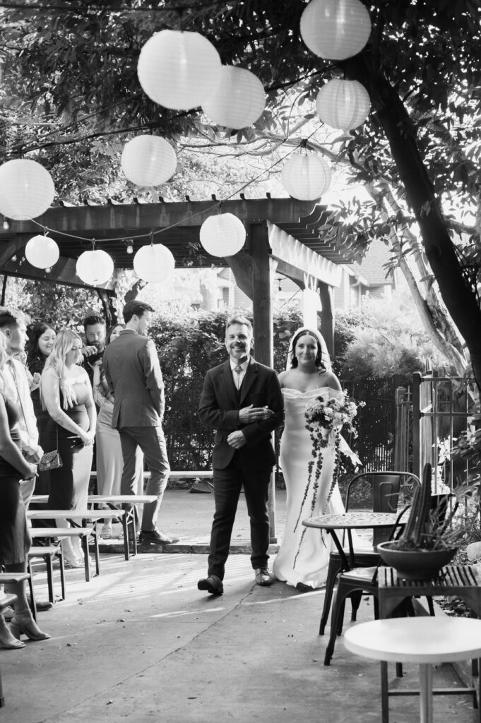 Bride and her dad walking into her intimate wedding ceremony at Urban Cowboy in Nashville, Tennessee.