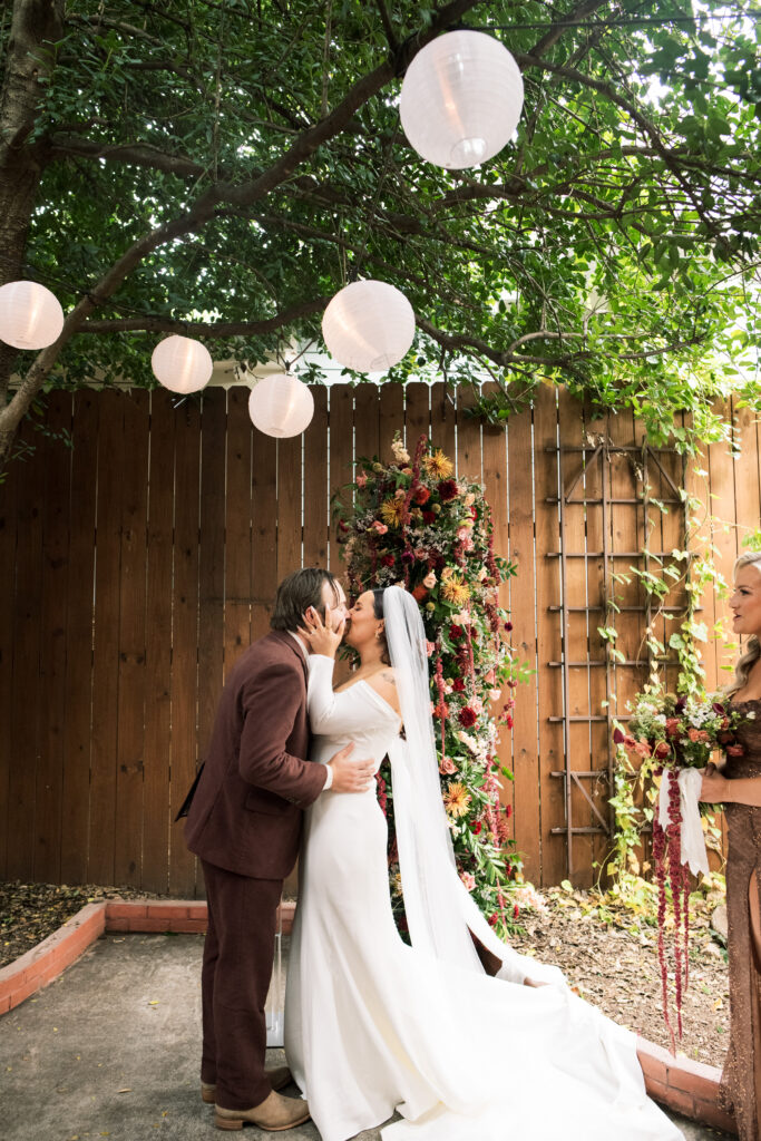 Bride and groom's first kiss at their intimate wedding ceremony at The Urban Cowboy in Nashville, Tennessee 