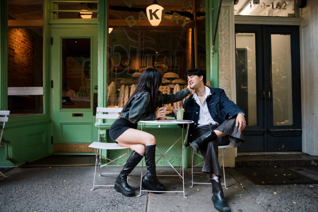 Couple sitting outside of a bakery in Soho 