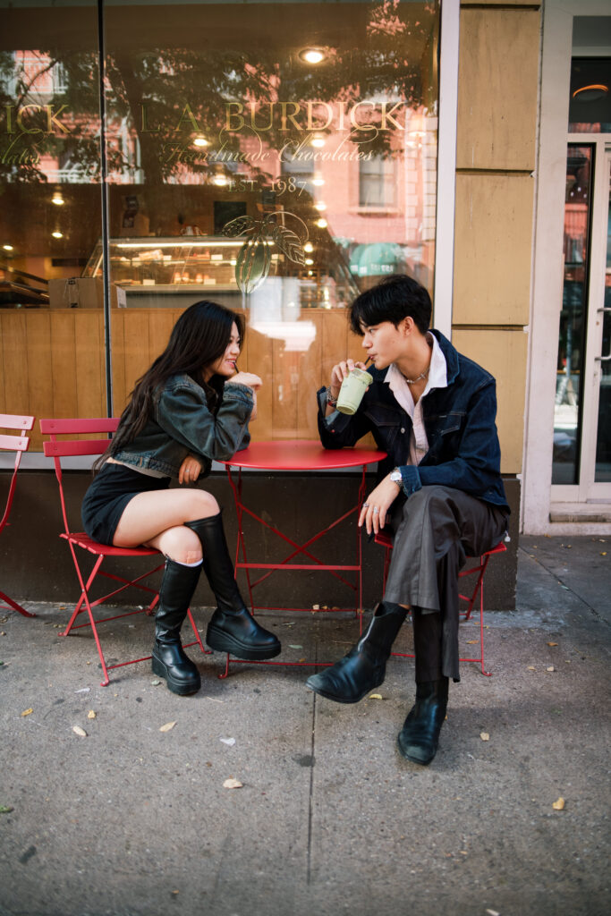 Couple sitting outside of a bakery in Soho 