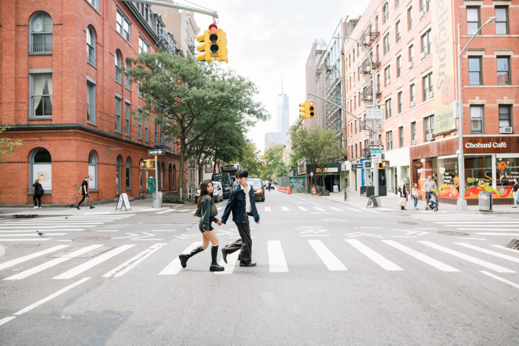 Image of couple running on the streets of Soho in NYC