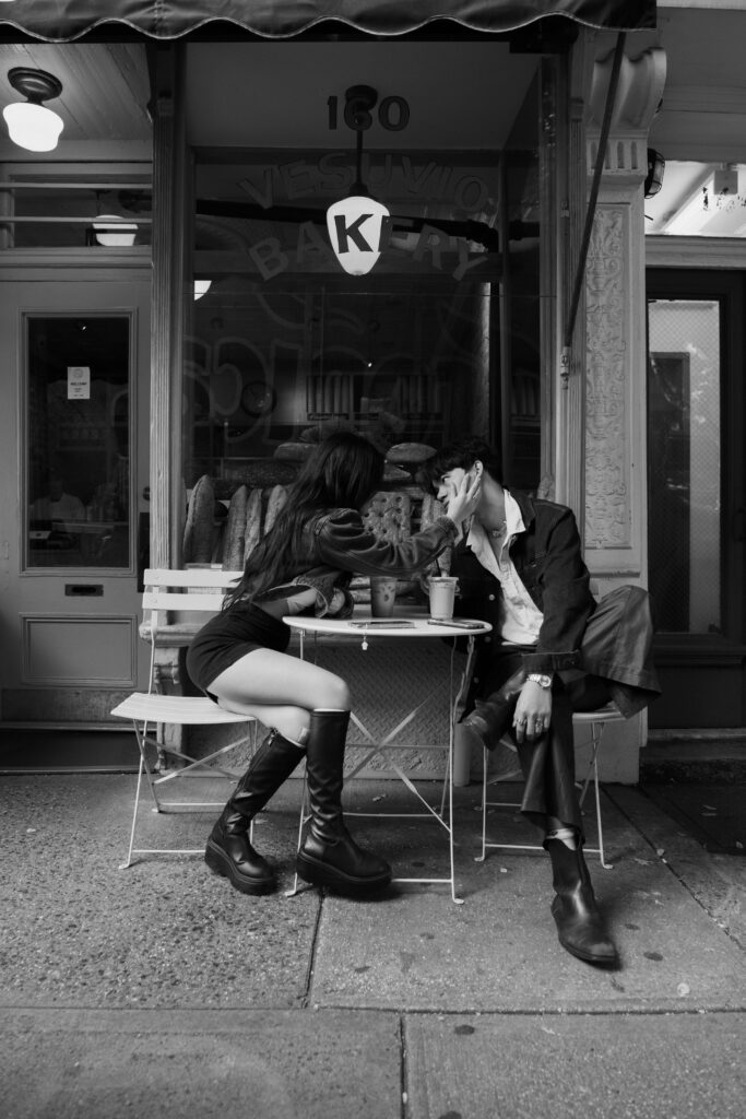 Couple sitting outside of a bakery in Soho 