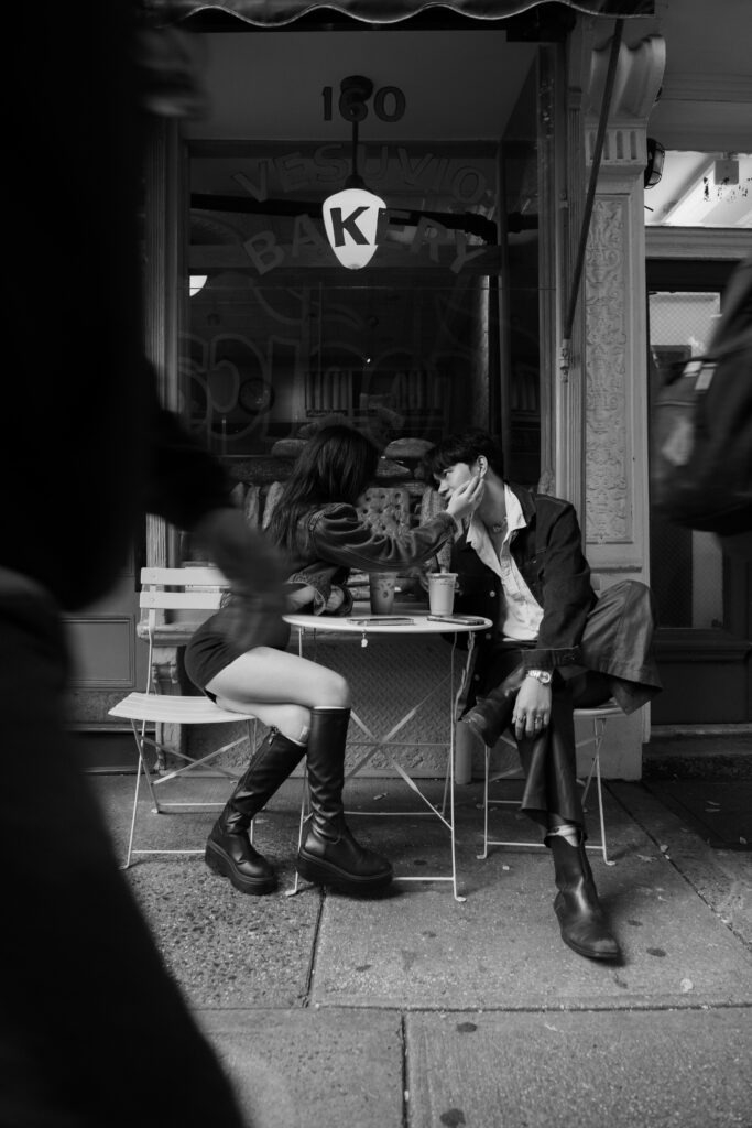 Couple sitting outside of a bakery in Soho 