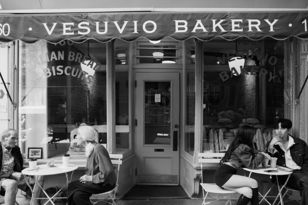 Couple sitting outside of a bakery in Soho 